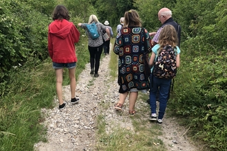 People Walking on Chalk Path 