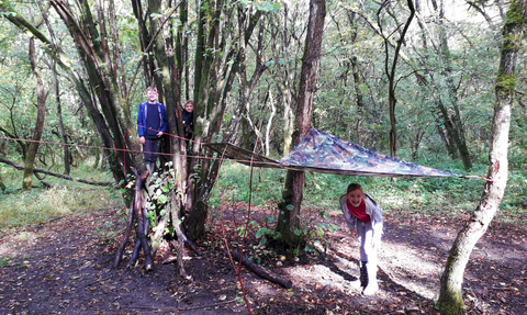 Children in woodland shelter