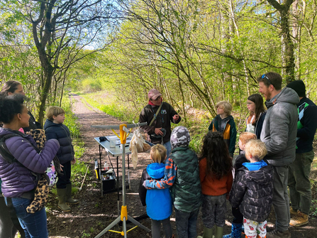 Wiltshire Wildlife team member demonstrates bird ringing to families