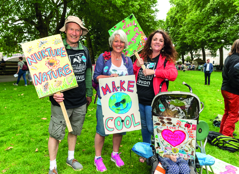 Wildlife Trust staff and child in pushchair attending climate change rally in London